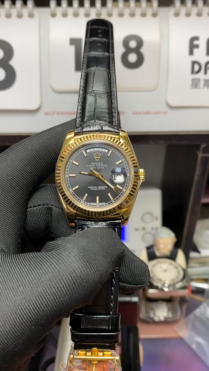 Rolex Day-Date Series 118135, Black Dial Gold Case with a leather strap, 36mm size.
